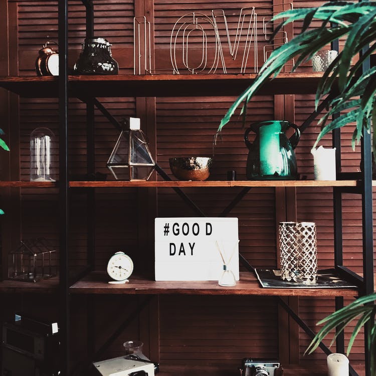 Free Shelves with decor and good day wish board Stock Photo